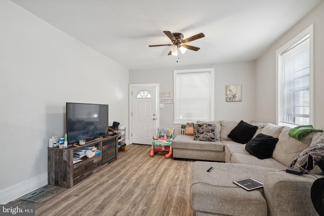 living room with hardwood / wood-style floors and ceiling fan