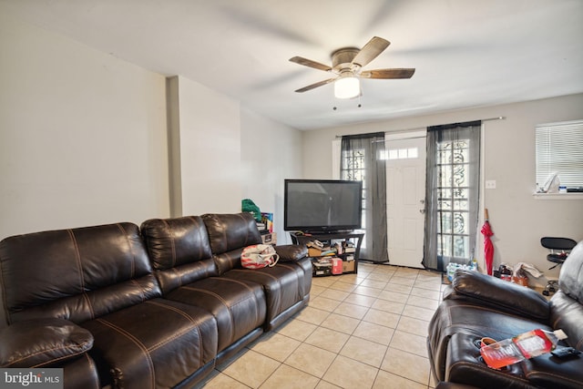 tiled living room with ceiling fan