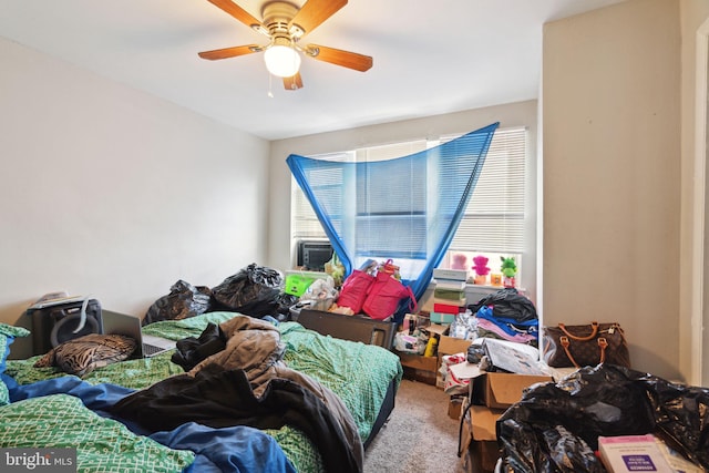 carpeted bedroom featuring ceiling fan and multiple windows