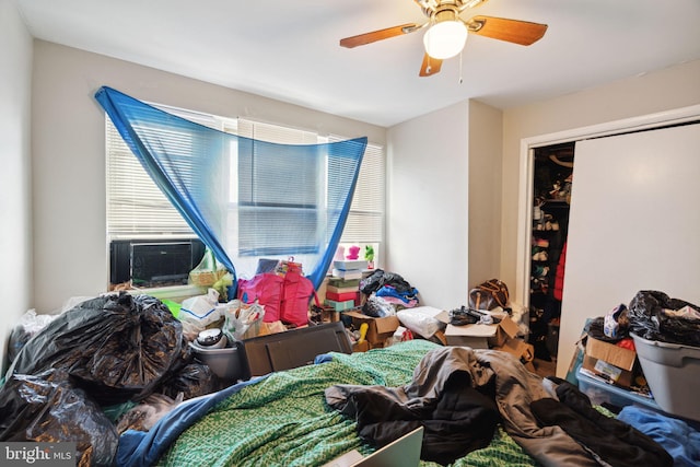 bedroom featuring a closet, ceiling fan, and cooling unit