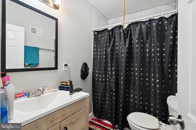 bathroom with vanity, toilet, and walk in shower