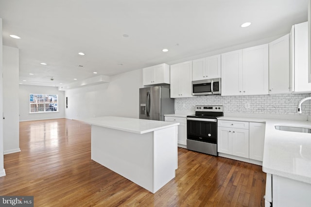 kitchen with white cabinetry, sink, and appliances with stainless steel finishes