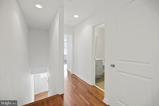 hall with hardwood / wood-style floors