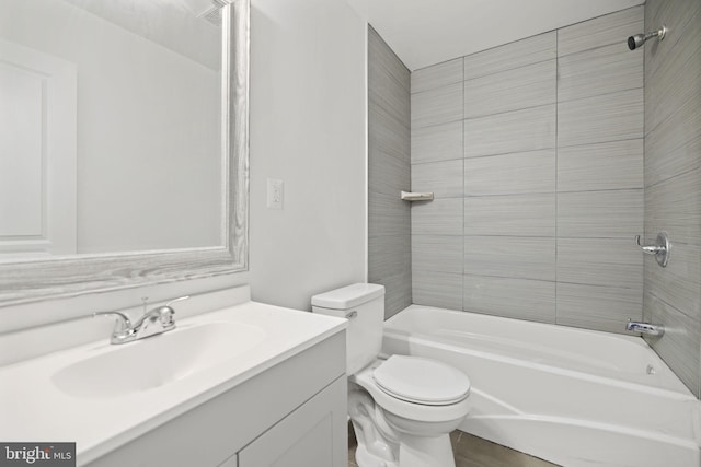 full bathroom with vanity, toilet, and tiled shower / bath