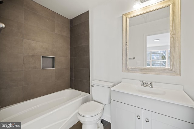 full bathroom featuring tiled shower / bath combo, toilet, and vanity