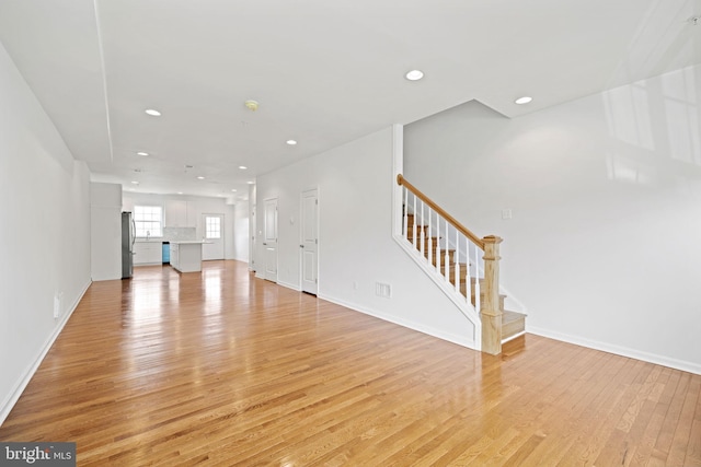 unfurnished living room featuring light wood-type flooring