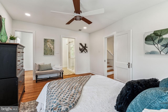 bedroom featuring hardwood / wood-style flooring, connected bathroom, and ceiling fan