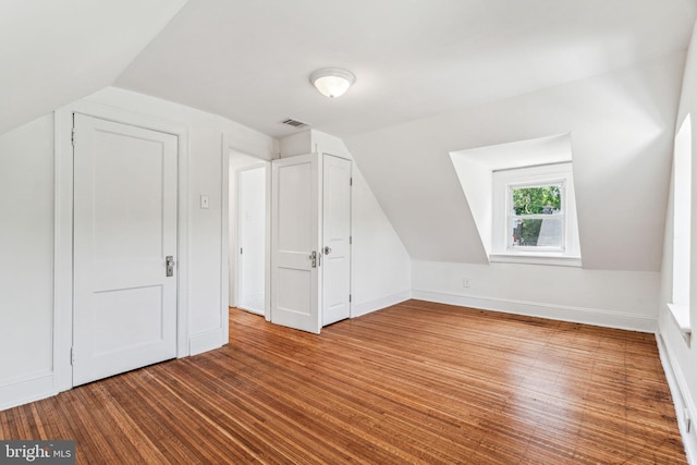 bonus room with wood-type flooring and lofted ceiling