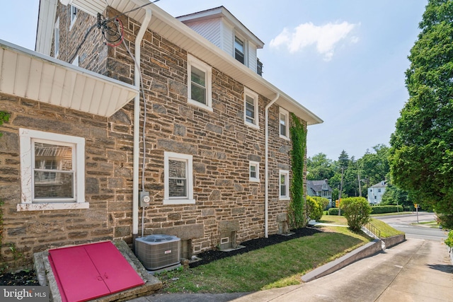 view of side of property featuring central AC