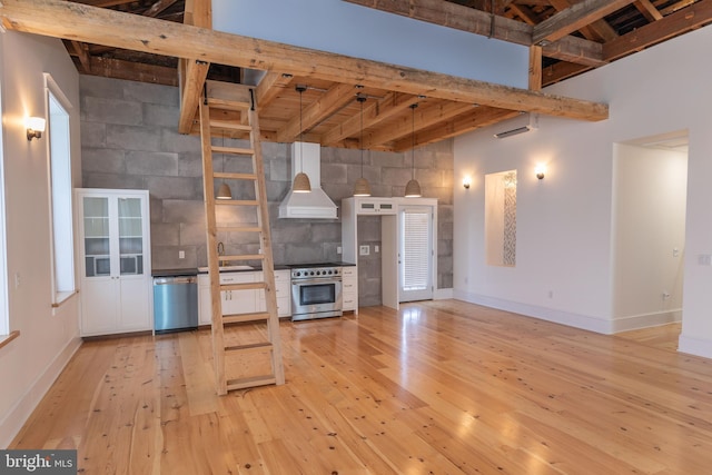 unfurnished living room featuring beamed ceiling, light hardwood / wood-style floors, wood ceiling, and sink