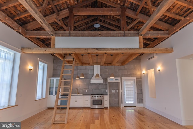 unfurnished living room featuring beam ceiling, sink, high vaulted ceiling, light hardwood / wood-style floors, and wood ceiling