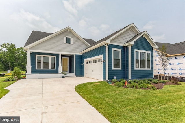 view of front of home with a front yard and a garage