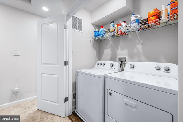 laundry room with washing machine and clothes dryer