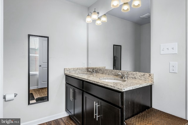 bathroom with vanity and hardwood / wood-style flooring