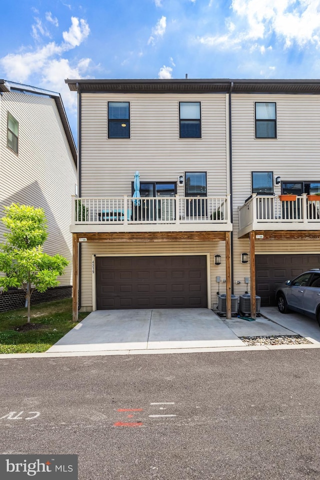 view of front facade with central AC unit and a garage