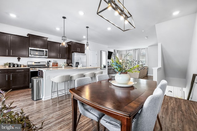 dining space with dark hardwood / wood-style flooring