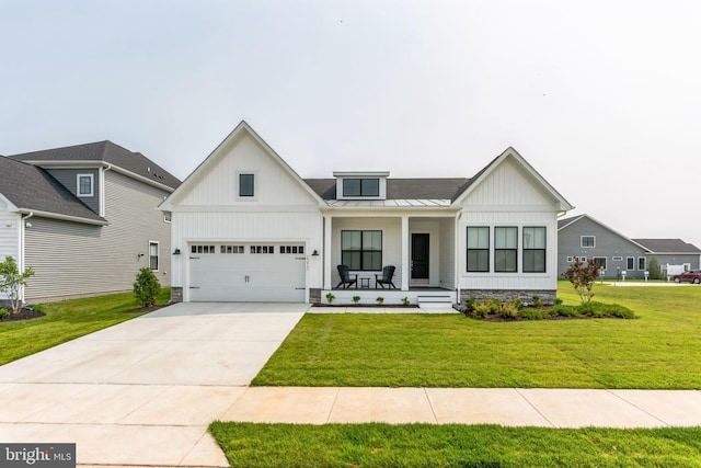 view of front of house featuring a garage, a porch, and a front yard