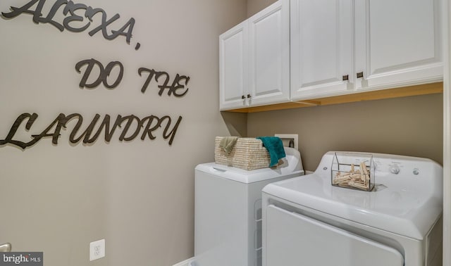 laundry area featuring cabinets and separate washer and dryer