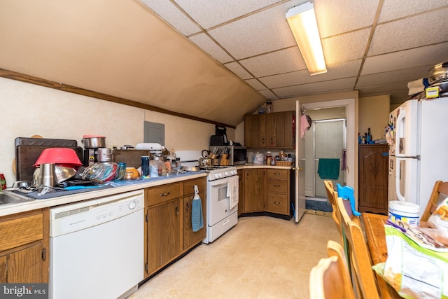 kitchen with lofted ceiling, a drop ceiling, and white appliances