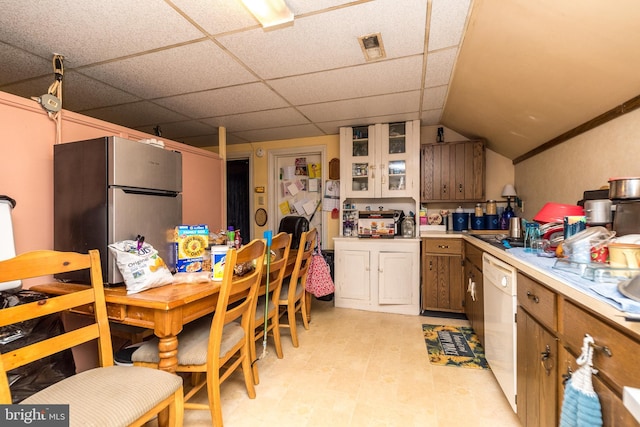 kitchen featuring stainless steel refrigerator, a paneled ceiling, dishwasher, and vaulted ceiling