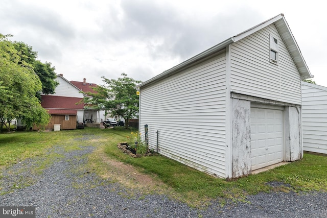 view of home's exterior with a garage and a lawn