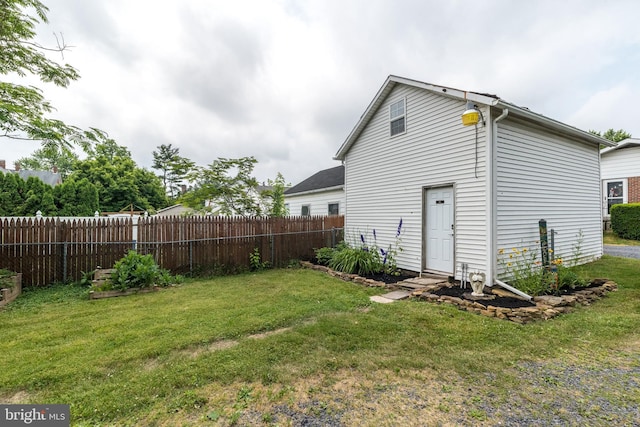 back of property featuring a lawn