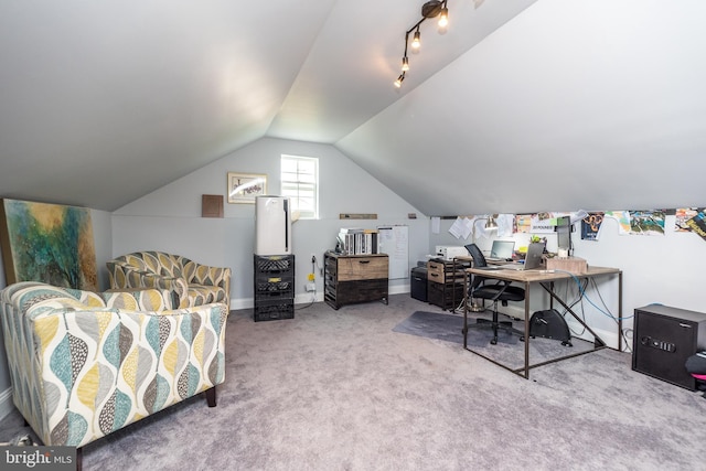 carpeted office space with rail lighting and vaulted ceiling