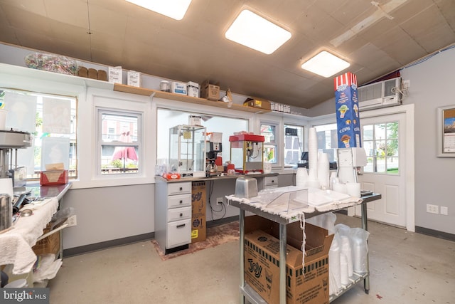 kitchen with kitchen peninsula, vaulted ceiling, and an AC wall unit