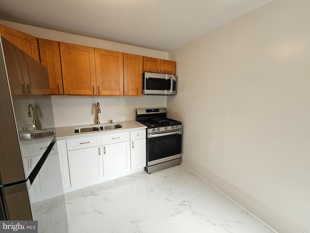 kitchen featuring sink, appliances with stainless steel finishes, and tasteful backsplash