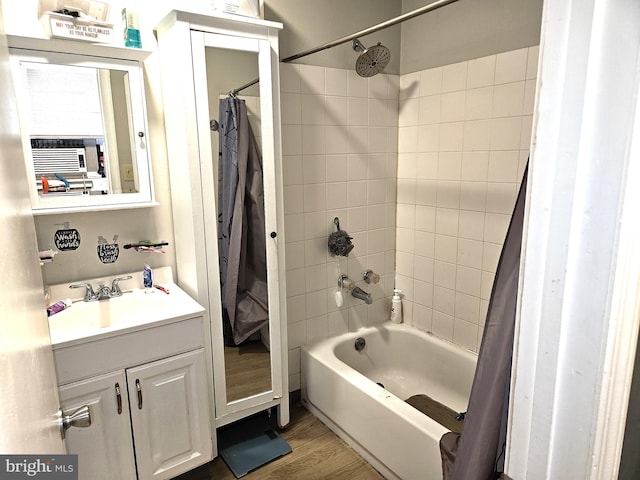 bathroom with shower / bath combo with shower curtain, wood-type flooring, and vanity