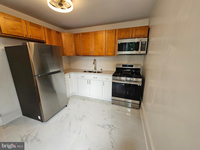 kitchen with sink, appliances with stainless steel finishes, and tasteful backsplash