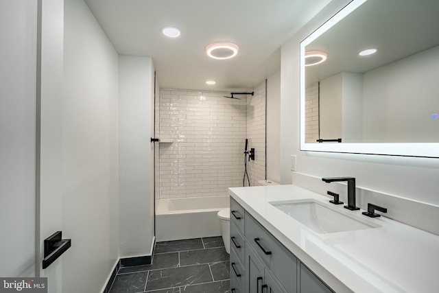 full bathroom featuring tile patterned floors, tiled shower / bath combo, toilet, and vanity