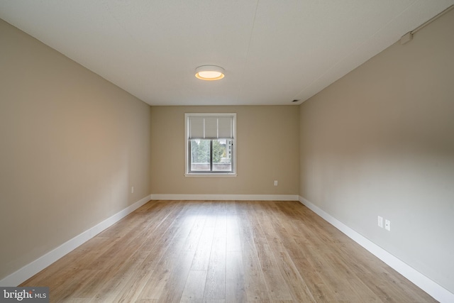 empty room with light hardwood / wood-style floors