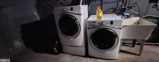 laundry area featuring washing machine and dryer and sink