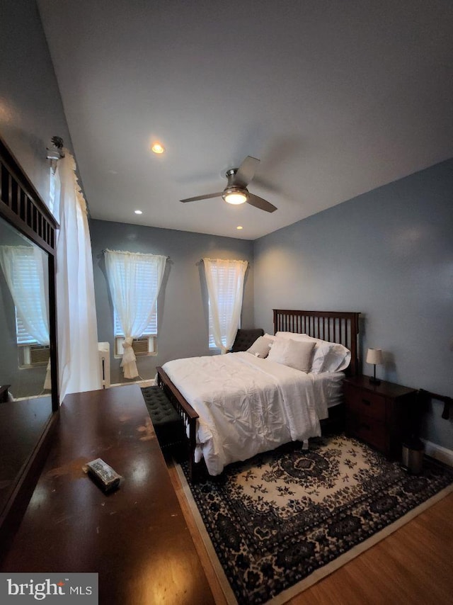 bedroom with hardwood / wood-style floors and ceiling fan