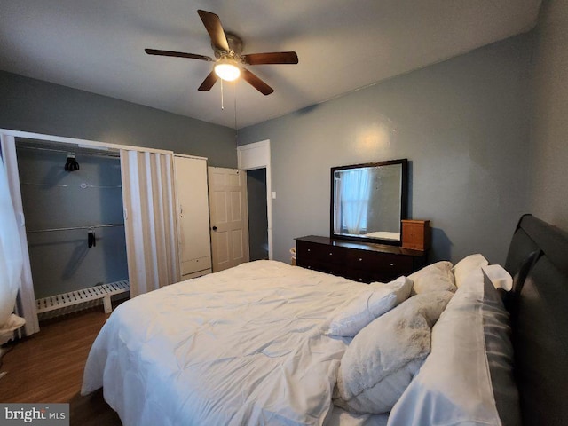 bedroom with ceiling fan and dark wood-type flooring