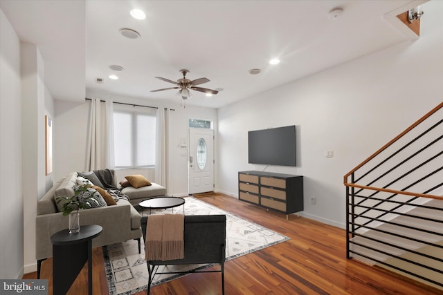 living room featuring ceiling fan and hardwood / wood-style floors