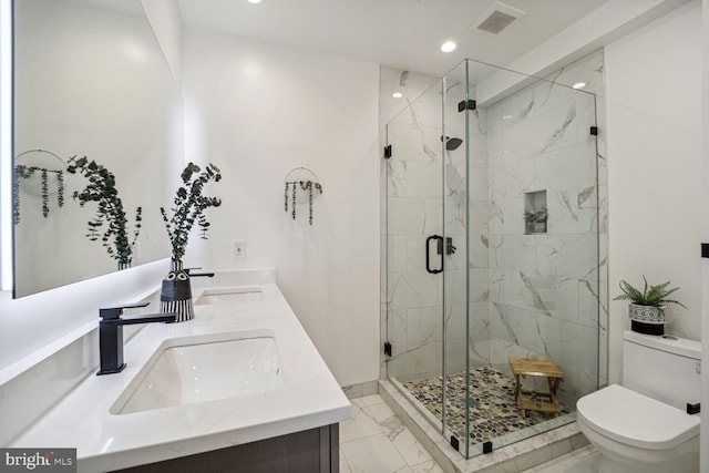 bathroom featuring dual vanity, toilet, tile patterned floors, and walk in shower