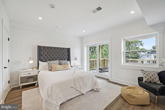 bedroom featuring access to exterior and hardwood / wood-style floors