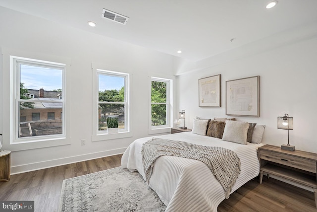 bedroom with dark hardwood / wood-style flooring