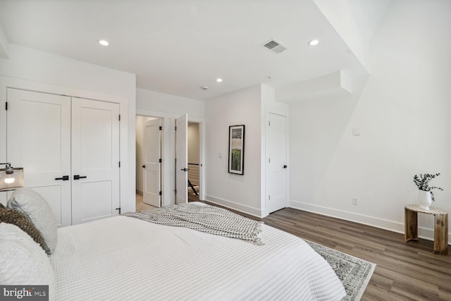 bedroom with a closet and dark wood-type flooring