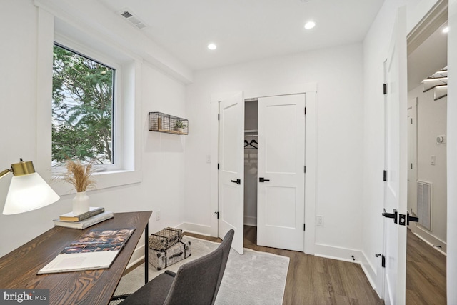 home office with dark wood-type flooring