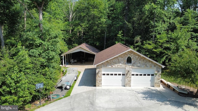 view of front of property featuring a garage and an outdoor structure