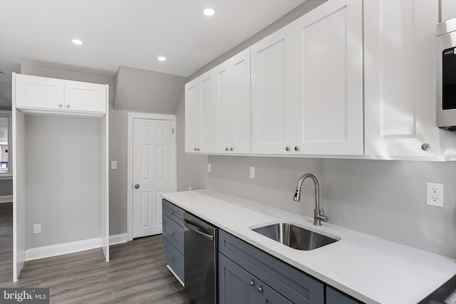 kitchen featuring light stone countertops, white cabinetry, sink, dark wood-type flooring, and stainless steel appliances