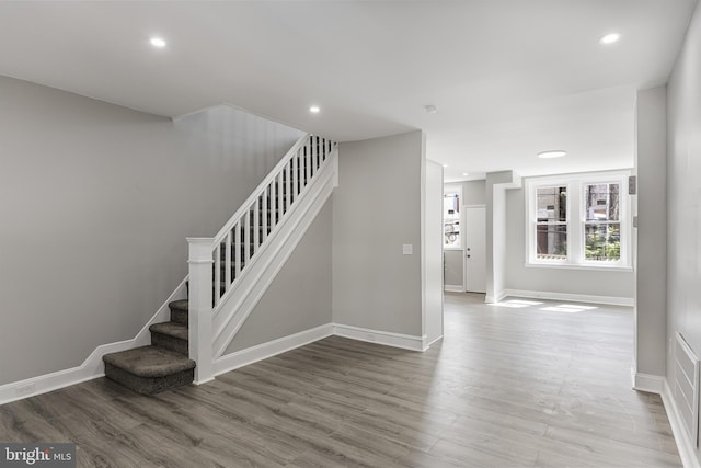 stairway with hardwood / wood-style flooring