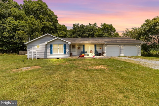 ranch-style home with a lawn and a garage