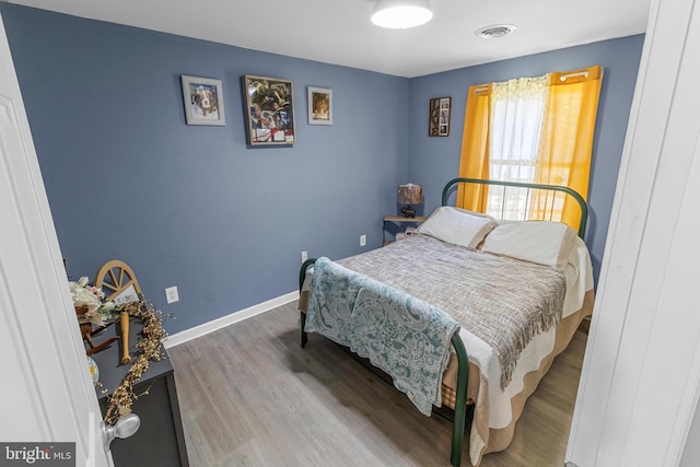 bedroom with wood-type flooring