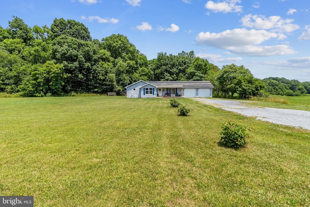 single story home featuring a garage and a front lawn