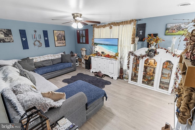 living room with ceiling fan and light hardwood / wood-style flooring