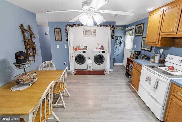 kitchen featuring white electric range oven, ceiling fan, independent washer and dryer, and light hardwood / wood-style flooring